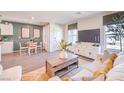 Open concept living room with modern decor, neutral colors, laminate floors, and a view of the dining area at 4955 Sage Mesa Ave # Lot 150, Las Vegas, NV 89139