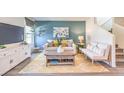Cozy living room featuring a teal accent wall, modern furniture, and natural light from a large window at 4955 Sage Mesa Ave # Lot 150, Las Vegas, NV 89139