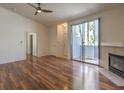 Spacious living room with sliding glass door, fireplace and wood floors at 4960 Harrison Dr # 214, Las Vegas, NV 89120