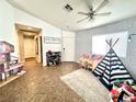Bright living area featuring tile floors and a playful teepee tent at 529 Regal Robin Way, North Las Vegas, NV 89084