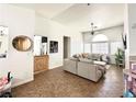 Open-concept living room with tile floors, a ceiling fan, and comfortable sofa at 529 Regal Robin Way, North Las Vegas, NV 89084