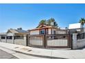 This house features a gated side yard providing extra secure parking at 5876 Tippin Dr, Las Vegas, NV 89130