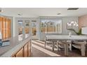 Bright dining room with modern chandelier, large windows, and stylish decor at 59 Desert Dawn Ln, Henderson, NV 89074