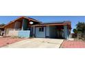 Charming home with solar panels, a driveway and a colorful two-tone exterior at 6700 Oak Valley Dr, Las Vegas, NV 89103