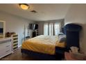 Bright main bedroom featuring a comfortable bed, TV, and a view of the outdoors at 6700 Oak Valley Dr, Las Vegas, NV 89103