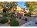 Charming home featuring desert landscaping and an inviting, brick paved driveway at 6954 Jacksboro Ct, North Las Vegas, NV 89084