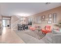 Bright and airy living room with neutral walls and staircase at 6954 Jacksboro Ct, North Las Vegas, NV 89084