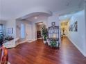 Inviting living area features hardwood floors, arched doorways, and an abundance of natural light at 7225 Millerbird St, North Las Vegas, NV 89084