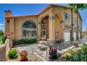 Beautiful home featuring a decorative stone entrance, a front patio and lovely landscaping at 7761 Cowboy Trl, Las Vegas, NV 89131