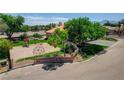Aerial view of a residential playground with equipment, mature trees, and green grass at 7761 Cowboy Trl, Las Vegas, NV 89131