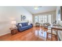 Comfortable living room with hardwood floors, vaulted ceiling, and bay window at 8428 Apple Hill Ct, Las Vegas, NV 89128
