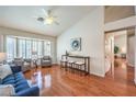 Bright living room with hardwood floors, vaulted ceiling, and bay window at 8428 Apple Hill Ct, Las Vegas, NV 89128