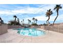 Inviting community pool surrounded by palm trees and a well-maintained deck for relaxation at 8567 Little Fox St, Las Vegas, NV 89123