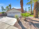 Charming single-story home featuring a two-car garage, mature landscaping, and a concrete driveway, perfect for suburban living at 8632 Skyward Ct, Las Vegas, NV 89145