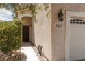 Charming home featuring a secure front door and a well-manicured garden at 9029 Tumblewood Ave, Las Vegas, NV 89143