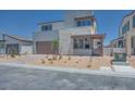 Gorgeous two-story home featuring a modern design, a welcoming entrance, and a well-maintained front yard at 9265 Frazer St, Las Vegas, NV 89166