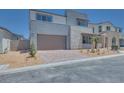Beautiful two-story home showcasing a well-manicured front yard, a two-car garage, and modern architectural design at 9265 Frazer St, Las Vegas, NV 89166