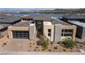 Beautiful modern home featuring a neutral color palette, stone accents, and a spacious two-car garage at 104 Tre Pietre St, Henderson, NV 89011