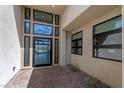 Modern home entryway featuring a glass front door, sidelights, and a beautiful lake view at 104 Tre Pietre St, Henderson, NV 89011