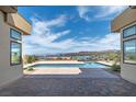 Stunning outdoor space featuring a swimming pool and views of the nearby lake at 104 Tre Pietre St, Henderson, NV 89011