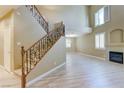 Spacious living room with lots of light, a fireplace, and staircase with decorative ironwork at 11478 Bargetto Ct, Las Vegas, NV 89141