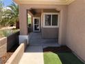 Inviting covered front porch with decorative columns and manicured garden bed at 1396 Couperin Dr, Henderson, NV 89052