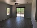 Spacious living room with tile floors, ceiling fan, and sliding door to backyard at 1396 Couperin Dr, Henderson, NV 89052