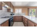 A kitchen featuring mosaic backsplash, stainless steel appliances, and lots of cabinet space at 1470 Elizabeth Ave # 1, Las Vegas, NV 89119