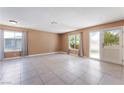 Spacious living room illuminated by natural light, neutral paint, and tile floors at 1470 Elizabeth Ave # 1, Las Vegas, NV 89119