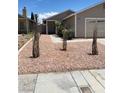 Charming single story home showcasing desert landscaping and a two car garage at 1501 Wintergreen Dr, Las Vegas, NV 89128