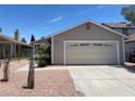 Charming single story home showcasing desert landscaping and a two car garage at 1501 Wintergreen Dr, Las Vegas, NV 89128