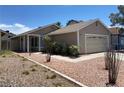Charming single story home showcasing desert landscaping and a two car garage at 1501 Wintergreen Dr, Las Vegas, NV 89128