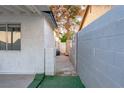 Narrow side yard walkway leading to a gated entrance and backyard at 1728 S Christy Ln, Las Vegas, NV 89142