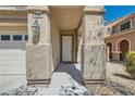 Inviting home entrance featuring a covered porch, decorative pillars, and a stylish front door at 216 Sharp Edge Ave, North Las Vegas, NV 89031