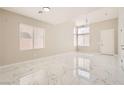 Bright, open living room featuring marble floors, high ceilings, and plenty of natural light at 216 Sharp Edge Ave, North Las Vegas, NV 89031