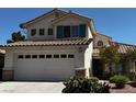 Inviting two-story home with a large garage and low-maintenance desert plants at 2419 Pebble Springs Ct, Henderson, NV 89074