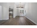 Bright entryway with hardwood flooring, white walls and trim, and a front door with transom window at 2420 Desert Butte Dr, Las Vegas, NV 89134