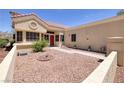Inviting front exterior with desert landscaping, tiled roof, and a glimpse of the red front door at 2420 Desert Butte Dr, Las Vegas, NV 89134