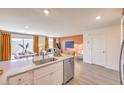 Open-concept design showcasing the kitchen with island, dining area, and a cozy living space at 2514 Petunia Garden Ave # 226, North Las Vegas, NV 89081