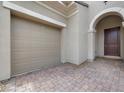 Elegant home featuring a neutral color palette, arched entryway, and two car garage at 26 Costa Tropical Dr, Henderson, NV 89011