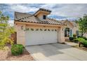 Charming single-story home featuring a two-car garage and desert landscaping with a mature tree at 2808 Cygnus St, Las Vegas, NV 89117