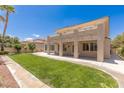 Expansive backyard with lush lawn, patio, and neutral stucco exterior provides space for entertaining and relaxation at 2846 Barrow Downs St, Las Vegas, NV 89135