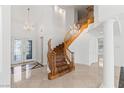 Grand foyer features a winding staircase, marble floors, and elegant chandeliers creating a luxurious entrance at 2846 Barrow Downs St, Las Vegas, NV 89135