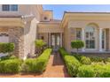Charming front entrance with manicured hedges, stone accents, and double doors adds curb appeal at 2846 Barrow Downs St, Las Vegas, NV 89135