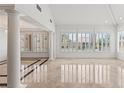 Spacious living room with large windows, plantation shutters, and polished marble floors at 2846 Barrow Downs St, Las Vegas, NV 89135