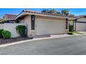Garage with neutral color scheme and brick-lined driveway at 3013 Plaza De Rosa, Las Vegas, NV 89102