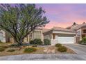 Charming single-story home with a tile roof, mature landscaping, and a two-car garage at 3053 Anchor Chain Dr, Las Vegas, NV 89128