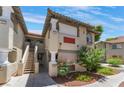 Condo buildings featuring staircases leading to upper units and desert landscaping at 3420 Winterhaven St # 202, Las Vegas, NV 89108