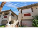 Exterior view of condo buildings with decorative columns, staircases, and red brick accents at 3420 Winterhaven St # 202, Las Vegas, NV 89108