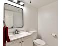 Contemporary powder room with sleek fixtures, framed mirror, and neutral color palette at 3484 Nightflower Ln # 2, Las Vegas, NV 89121
